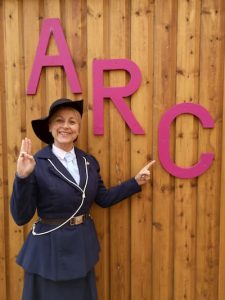 Adult dressed in old guiding uniform outside the ARC building